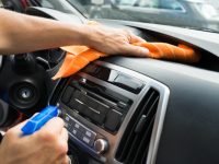 Male Worker Cleaning Car Dashboard